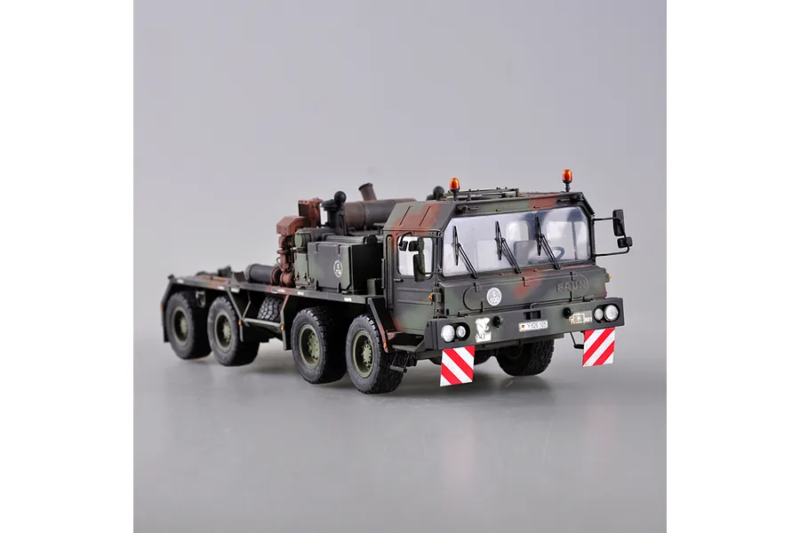 A 1/35 scale model of a German Faun SLT-56 tank transporter truck, featuring a camouflage paint scheme, hazard warning panels, and detailed military markings.