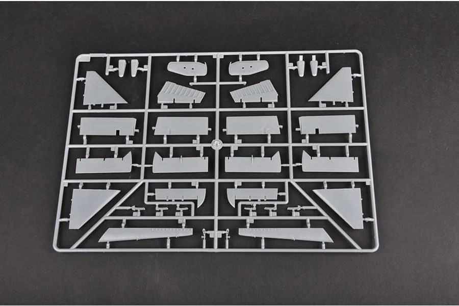 A grey plastic sprue containing various aircraft model parts, including wing sections and control surfaces, for a 1/32 scale model kit.