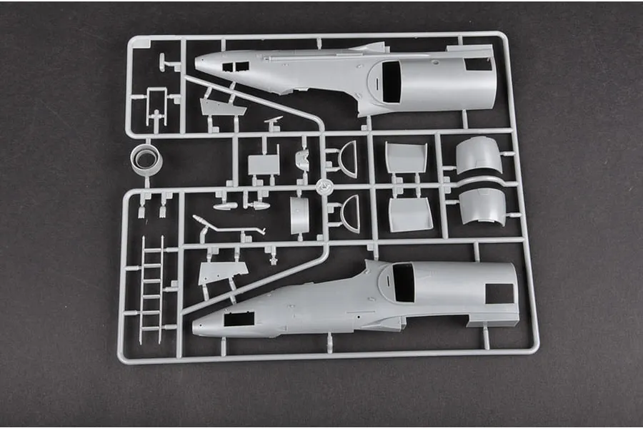 A grey plastic sprue from a Trumpeter 1/32 A-4M Skyhawk model kit, featuring fuselage halves and various small aircraft components.