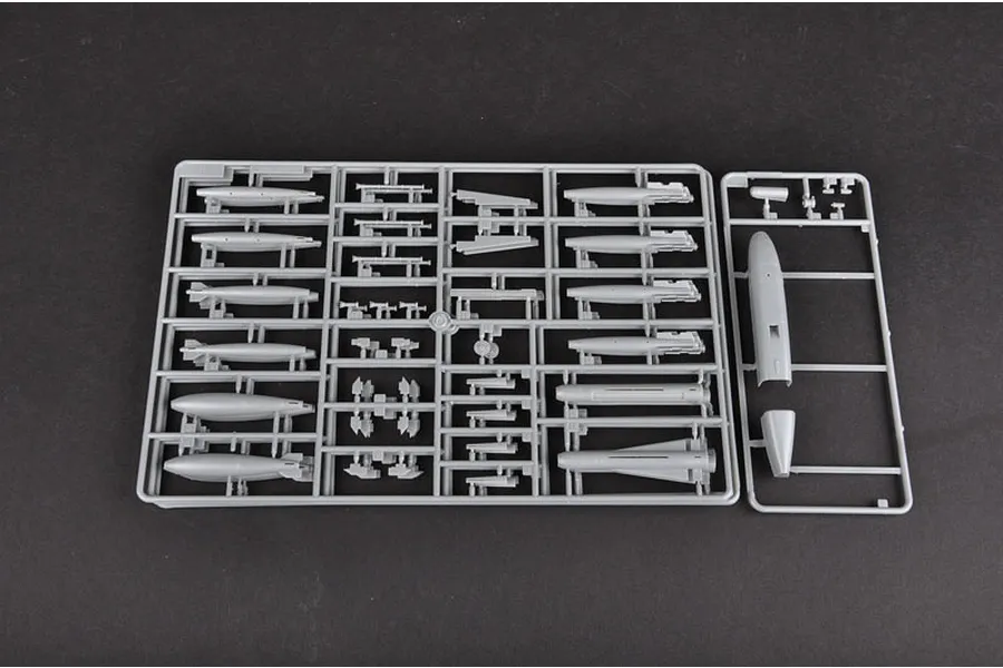 A grey plastic sprue containing various model aircraft weapon components and external fuel tanks for a 1/32 scale model kit.