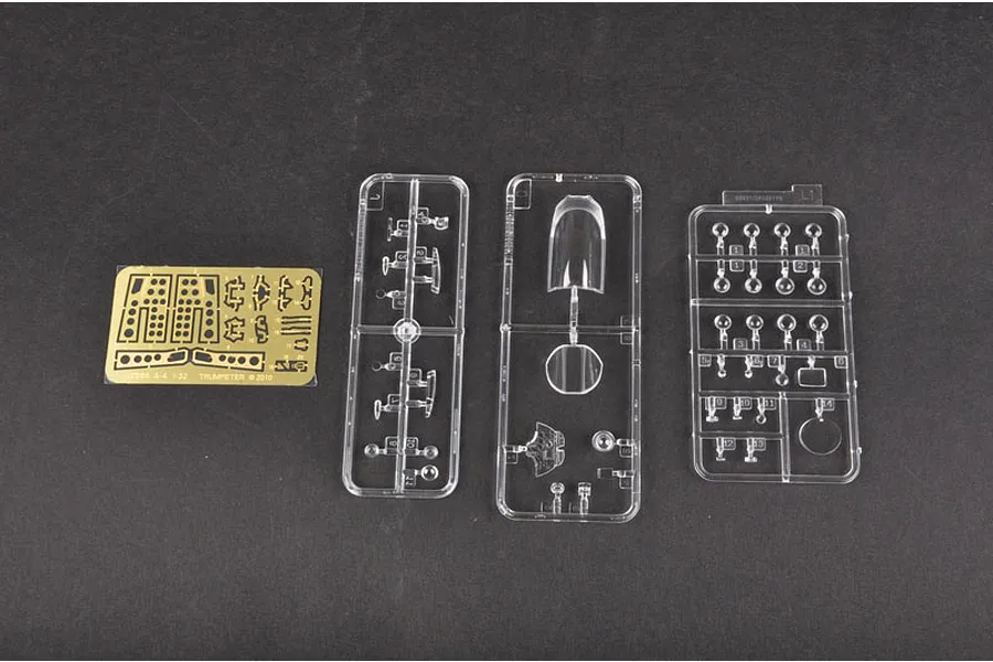 A photo-etched brass fret and three clear plastic model kit sprues for the Trumpeter 1/32 A-4M Skyhawk model kit.