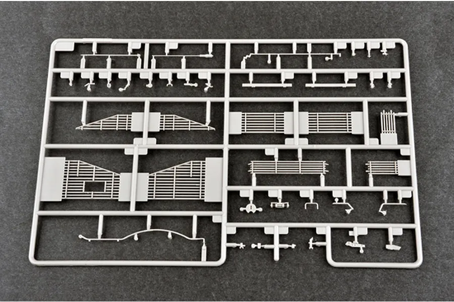 A grey plastic sprue containing various model parts for a 1/35 scale military vehicle kit, including slat armor panels.