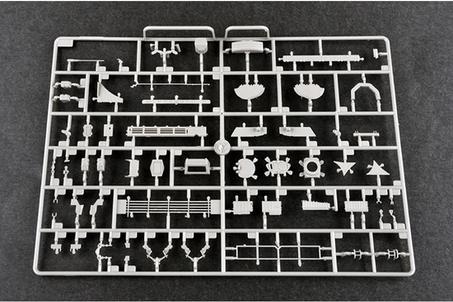 A grey plastic sprue containing various unpainted model kit parts for a 1/35 scale military vehicle, laid out on a dark grey surface.