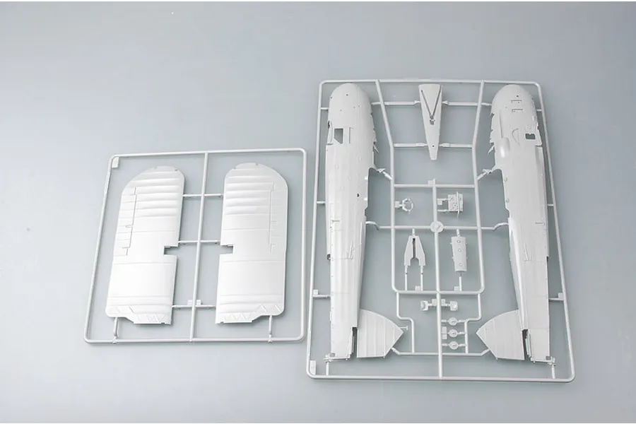Two grey plastic model kit sprues containing aircraft fuselage and wing parts for a Fairey Swordfish model.