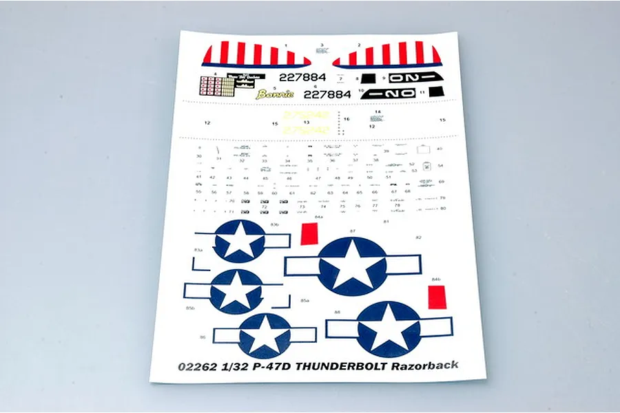 A decal sheet for a 1/32 scale P-47D Thunderbolt model kit, featuring US military insignia, serial numbers, and nose art markings on a white backing.