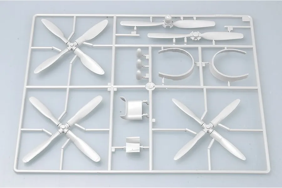 A grey plastic model kit sprue containing propeller blades and circular engine cowling parts for a 1/32 scale aircraft model.