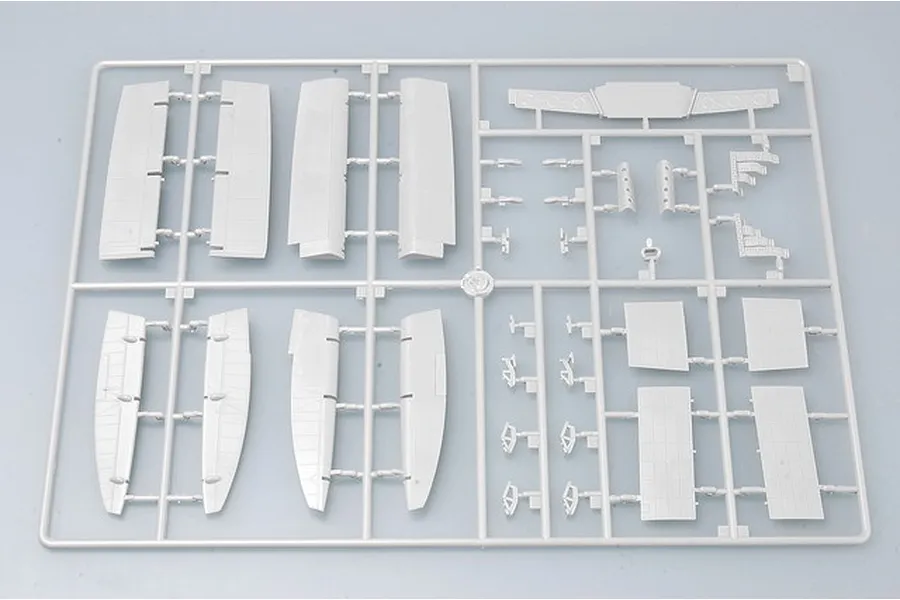 A grey plastic sprue containing various aircraft model parts, including wing sections and control surfaces, for a 1/32 scale model kit.