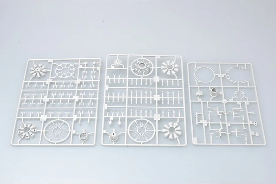 Three grey plastic model kit sprues containing engine components for a 1/32 scale P-47 Thunderbolt model.