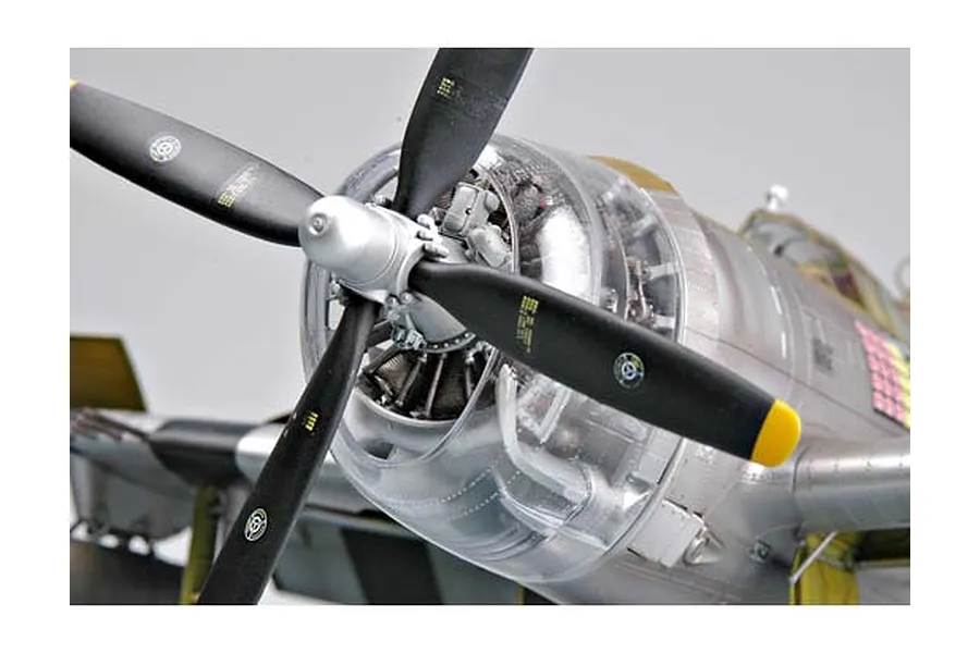 Close-up of a P-47 Thunderbolt model aircraft showing the propeller, radial engine, and clear engine cowling.