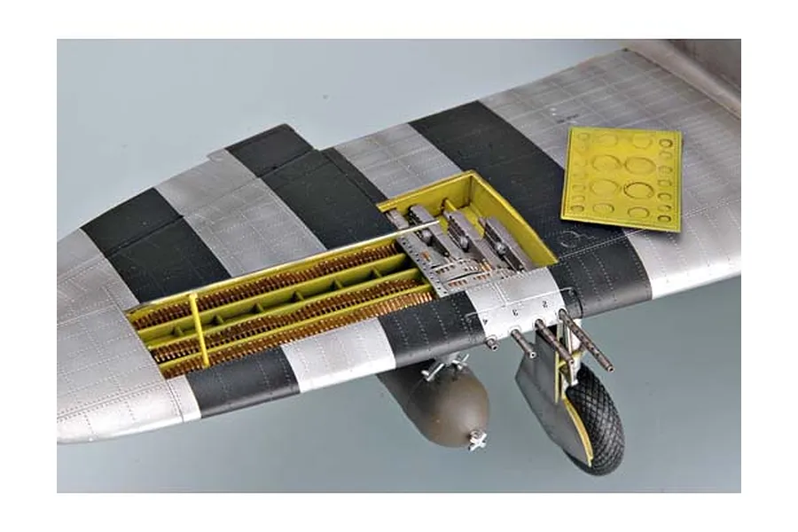 Close-up of a 1/32 scale P-47 Thunderbolt model wing showing the open gun bay, machine guns, and landing gear.