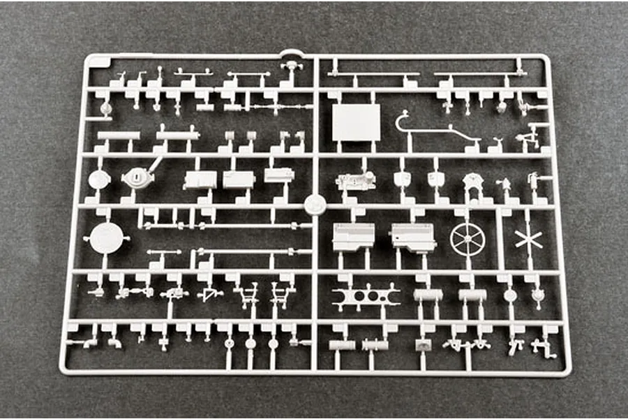 A grey plastic sprue containing various small model parts for a 1/35 scale military vehicle kit.