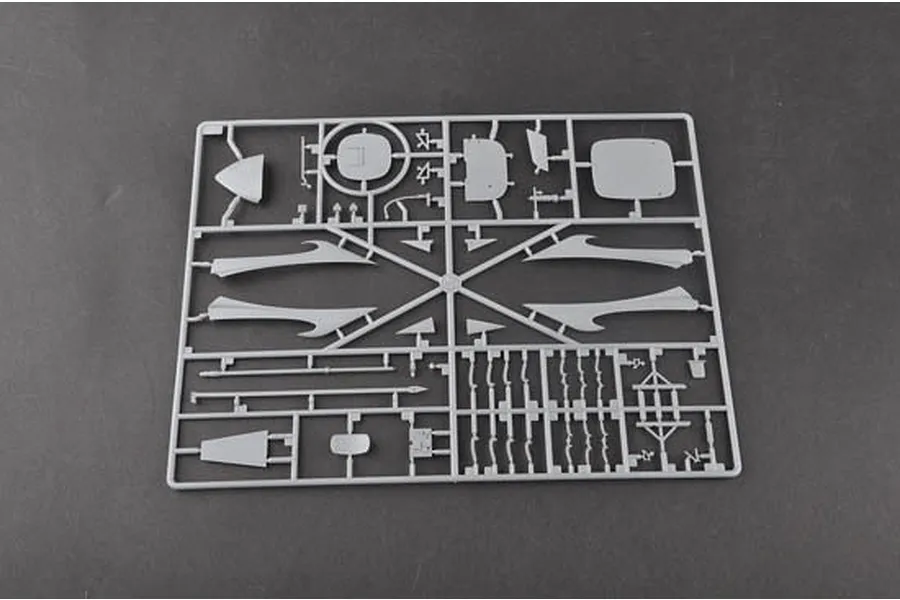 A grey plastic model kit sprue containing various aircraft parts against a dark grey background.