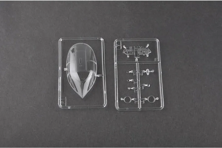 Clear plastic sprue parts for a 1/48 scale model aircraft kit, including a cockpit canopy and small instrument panel components.