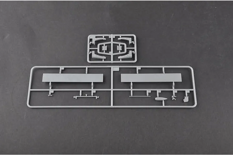Two grey plastic model kit sprues containing aircraft parts on a dark grey background.