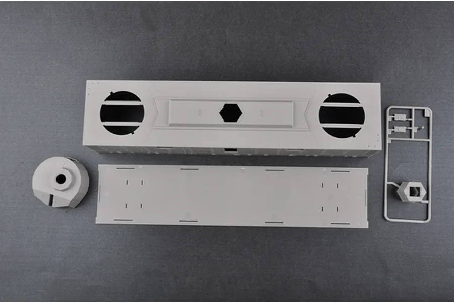 Top-down view of unpainted grey plastic model kit parts for a Trumpeter 1/35 Soviet PL-37 light artillery wagon on a dark grey background.