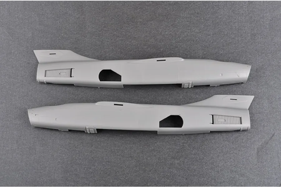 Two grey plastic model aircraft fuselage halves for a 1/48 scale Trumpeter EA-3B Skywarrior kit, laid flat on a grey surface.