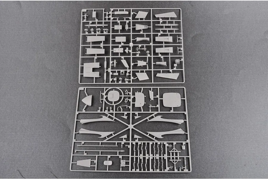Two grey plastic model kit sprues containing various aircraft parts laid out on a flat surface.