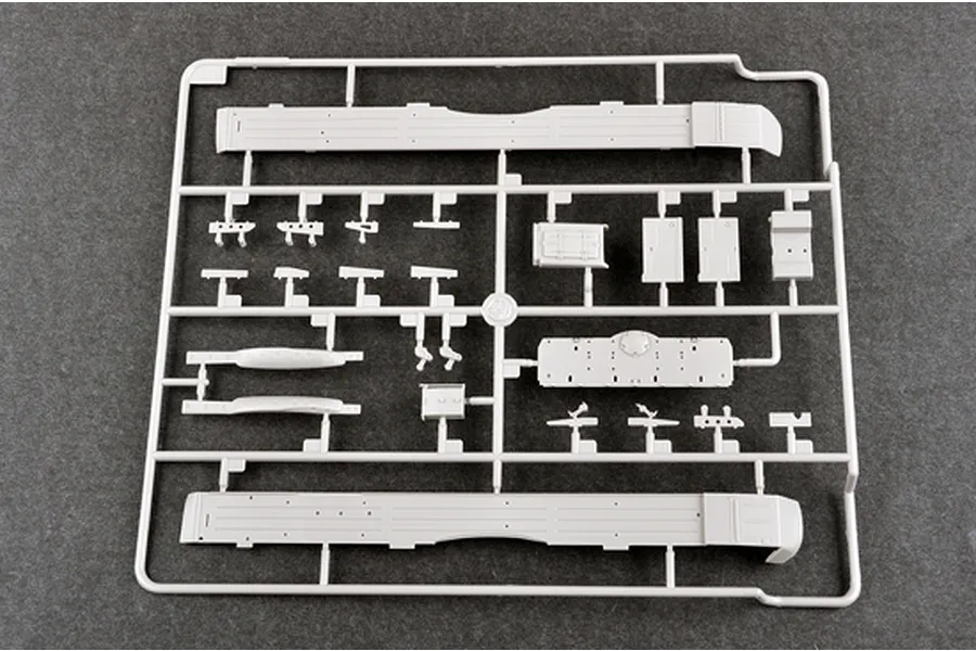 A grey plastic sprue containing various model tank parts for a 1/35 scale Trumpeter T-72B3M kit, including side skirts and small components.