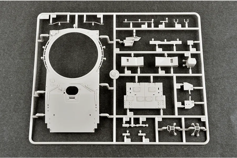 A grey plastic model kit sprue containing parts for a 1/35 scale tank, including a large turret top piece and various smaller components.