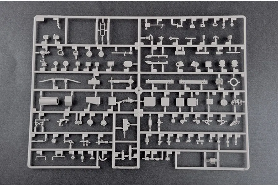 A grey plastic sprue containing various small parts for a 1/35 scale model kit, laid out on a dark grey background.