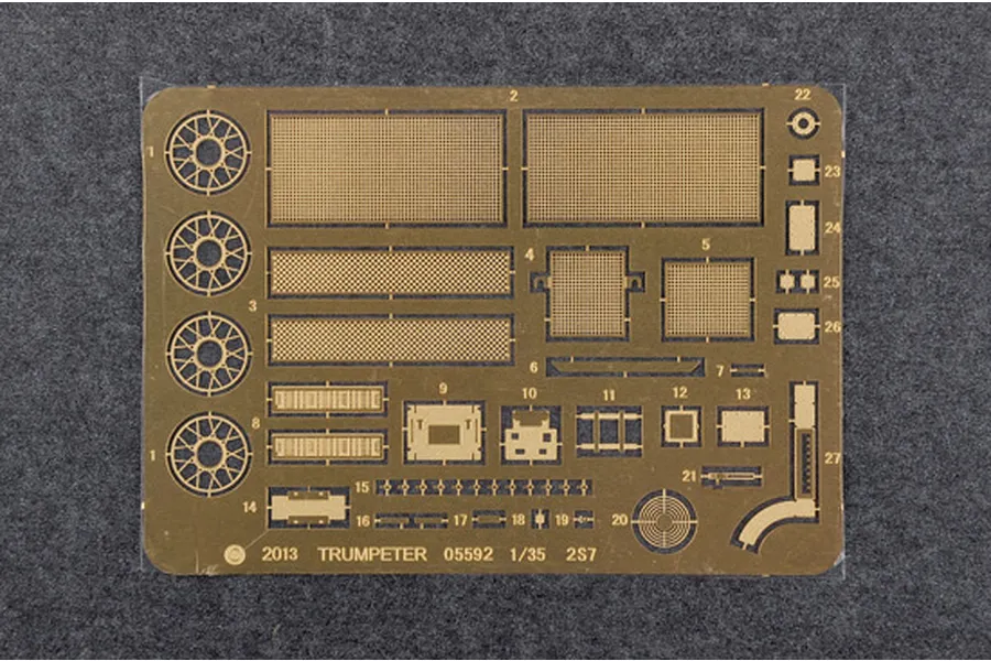 A photo-etched brass fret for a 1/35 scale Trumpeter 2S7 model kit, featuring various mesh screens, circular parts, and small detail components.