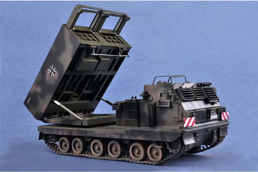 A 1/35 scale plastic model of a German MARS mobile artillery rocket system with its launcher raised, set against a blue background.