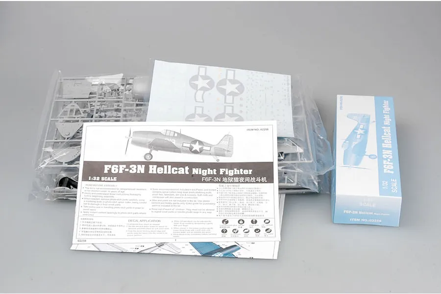 Trumpeter 1/32 F6F-3N Hellcat Night Fighter model kit contents including plastic sprues in bags, instruction manual, decal sheet, and small box.