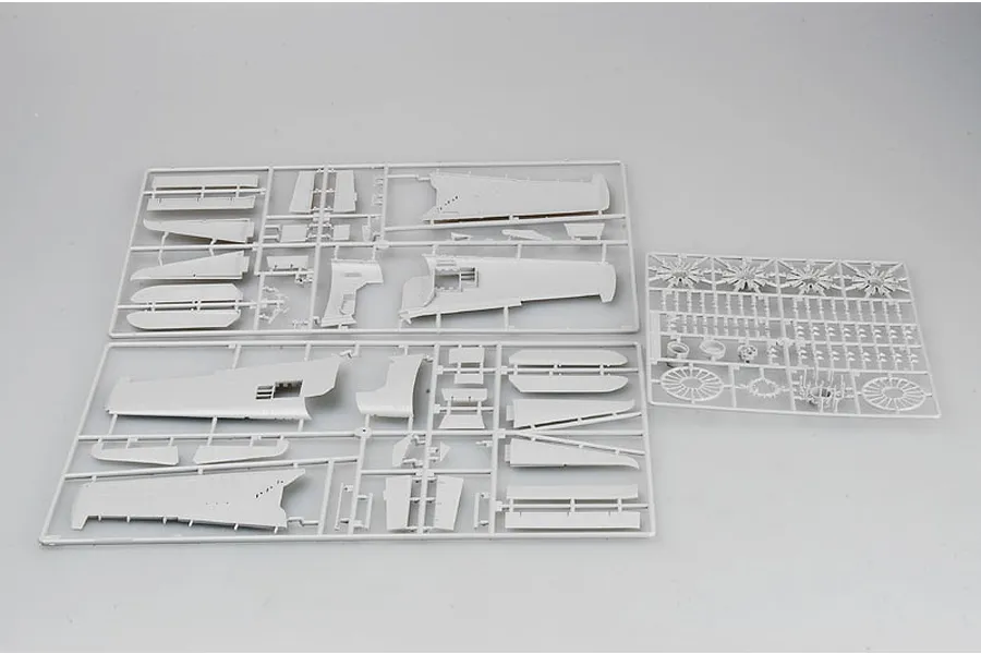 Three grey plastic model kit sprues containing aircraft parts for a 1/32 scale model aircraft kit.
