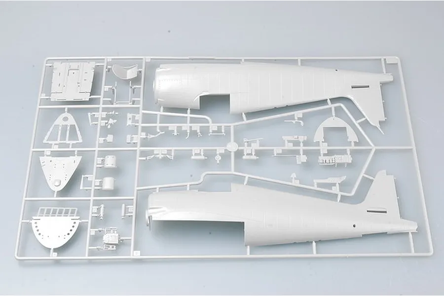 A grey plastic model kit sprue containing fuselage halves and various cockpit components for a 1/32 scale aircraft model.