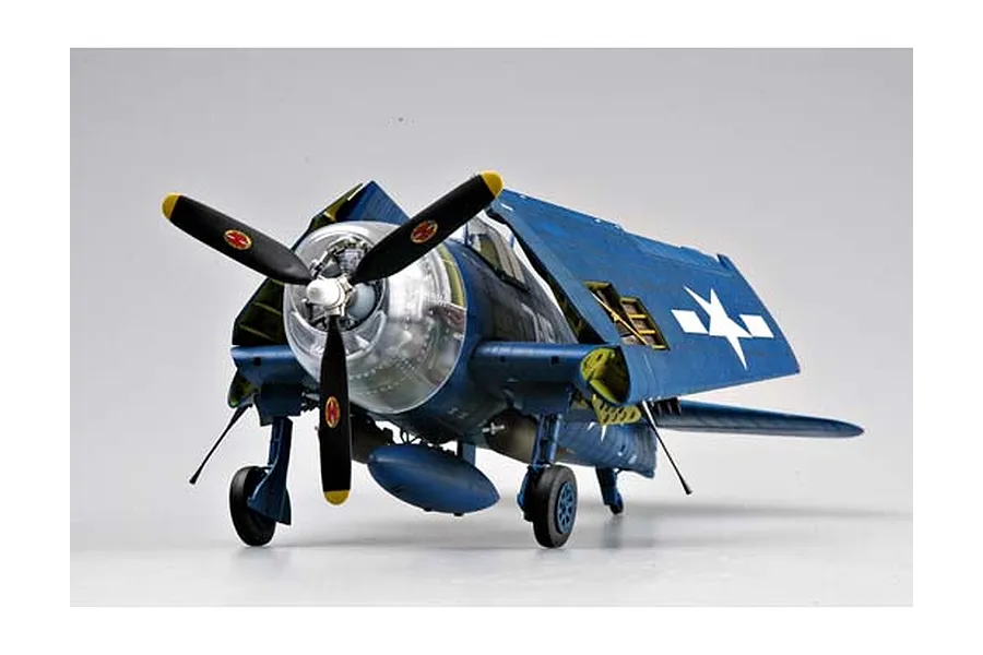 A 1/32 scale plastic model of a US Navy F6F Hellcat fighter plane with folded wings, displayed on a plain white background.