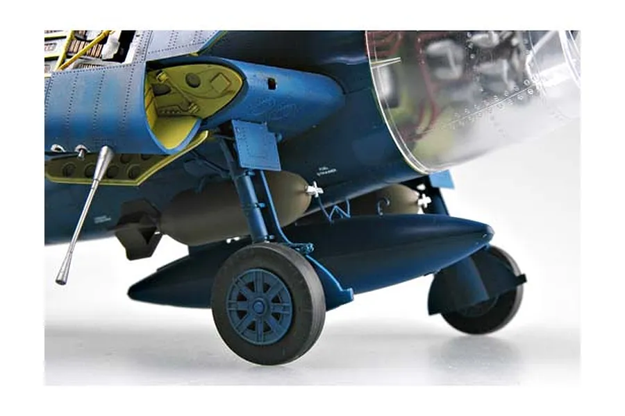 Close-up of the landing gear and underside of a 1/32 scale Trumpeter F6F-5N Hellcat model aircraft, showing detailed blue fuselage and external fuel tank.