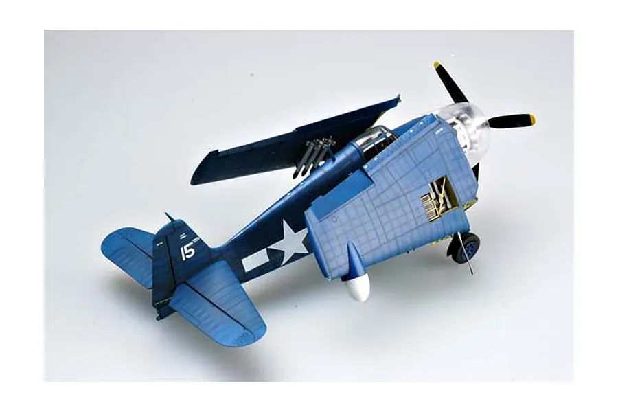 A high-angle view of a completed 1/32 scale Trumpeter F6F-5N Hellcat model aircraft with folded wings, painted in navy blue with US insignia.