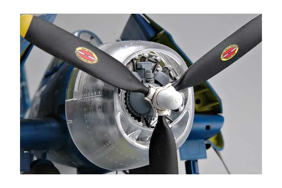 Close-up of a 1/32 scale model F6F Hellcat aircraft showing the propeller, engine, and a clear plastic engine cowling.