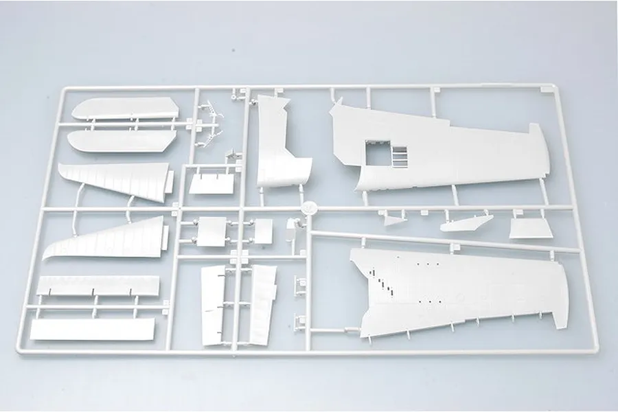 A grey plastic sprue containing various model aircraft wing and fuselage parts for a 1/32 scale model kit.