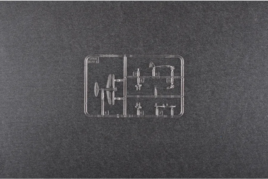 A clear plastic sprue containing small aircraft parts for a 1/350 scale model kit, set against a dark grey textured background.