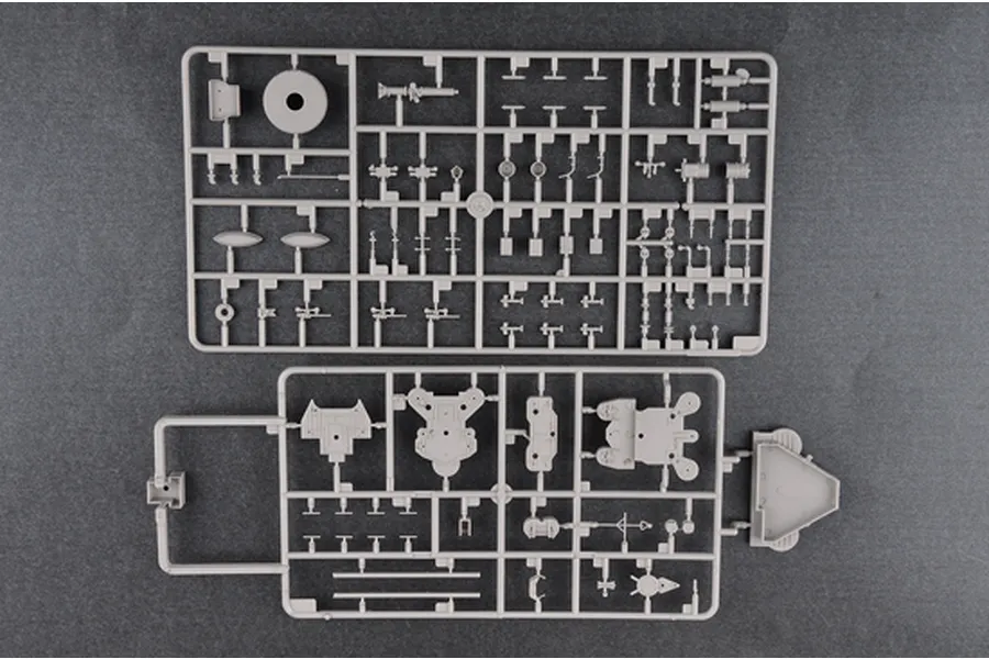 Two grey plastic model kit sprues containing various small parts for a 1/350 scale battleship model, laid out on a dark grey surface.