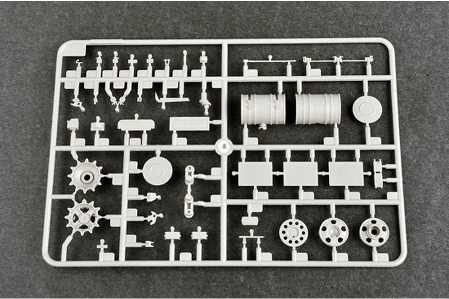 A grey plastic sprue from a Trumpeter 1/35 scale model kit containing various tank parts including wheels, fuel drums, and small mechanical components.