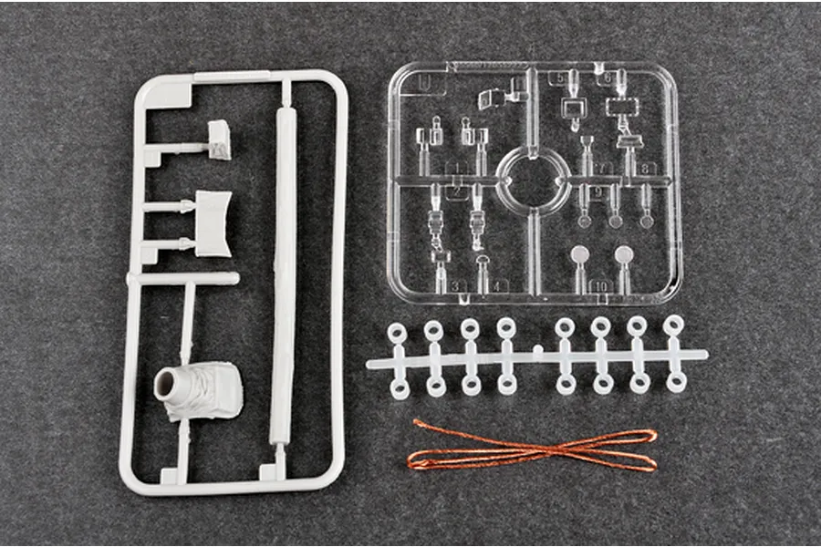 Plastic model kit sprues and copper wire for a 1/35 scale tank model on a grey background.