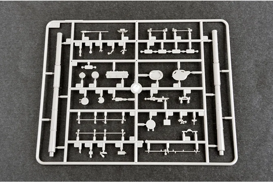 A grey plastic sprue from a Trumpeter 1/35 scale model kit containing various small tank parts and two long cylindrical components.