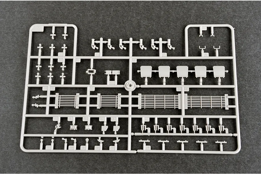 A grey plastic sprue containing various small parts for a 1/35 scale model tank kit, including grilles, brackets, and small mechanical components.