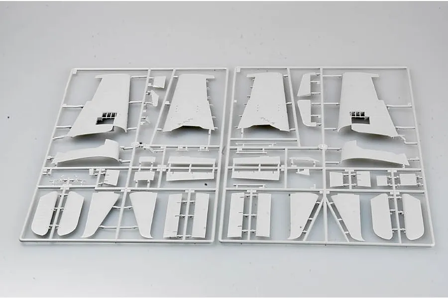 Two grey plastic model kit sprues containing aircraft wing and tail components for a 1/32 scale model.