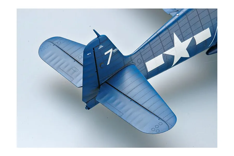 Close-up of the tail section of a blue F6F-5 Hellcat model aircraft, showing the rudder with number 7 and US military insignia.