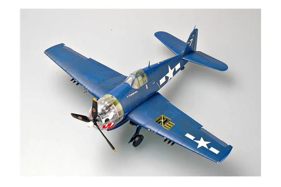 A high-angle studio shot of a fully assembled and painted 1/32 scale F6F-5 Hellcat model aircraft in dark blue livery with US military markings.