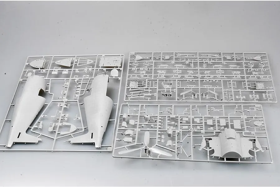 Three grey plastic model kit sprues containing various aircraft parts for a 1/32 scale F6F-5 Hellcat model.