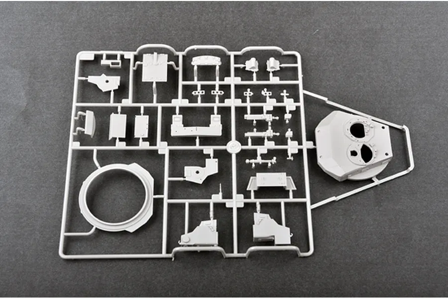 A grey plastic sprue containing various model tank parts, including a turret shell, for a 1/35 scale military model kit.