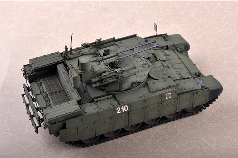 A high-angle view of a 1/35 scale plastic model of a BMPT Terminator tank, painted in olive green with the number 210 on the side.