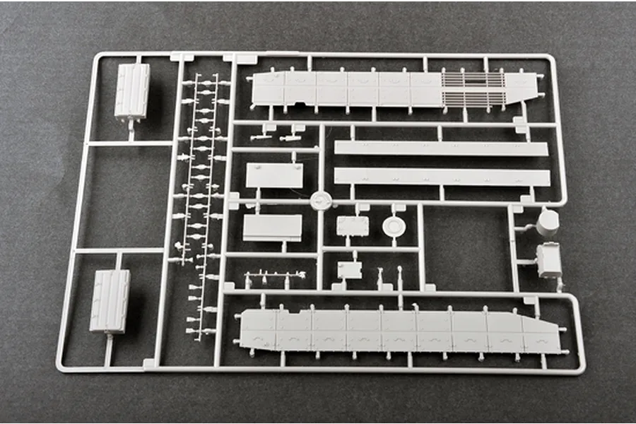 A grey plastic sprue containing various model tank parts, including side skirts and small components, for a 1/35 scale model kit.