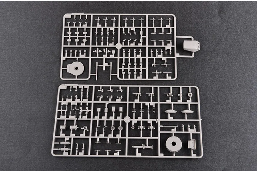Two grey plastic model kit sprues containing various small parts for a 1/350 scale battleship model, laid out on a dark grey surface.