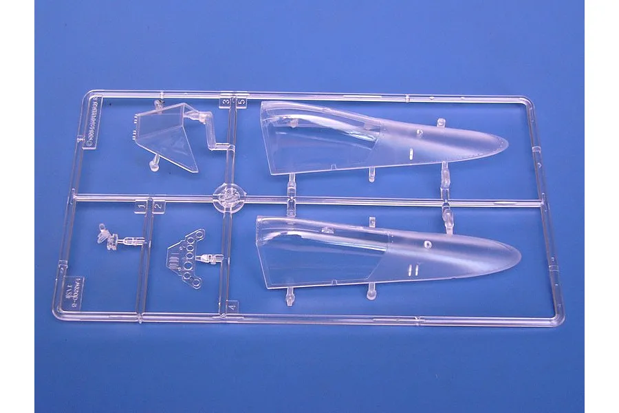 A clear plastic sprue containing aircraft canopy parts and instrument panel components for a 1/24 scale model kit.