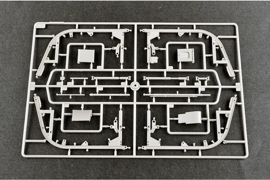 A grey plastic model kit sprue containing various structural and mechanical parts for a 1/35 scale military vehicle model.